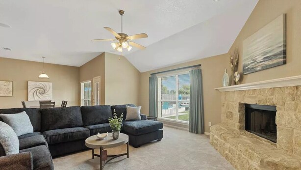 A living room with a sectional sofa, a fireplace, and a ceiling fan. - Spacious Home. Pool. Hot Tub. Grill. Pool Table. 4 Bed. 2 Bath. (Watauga)