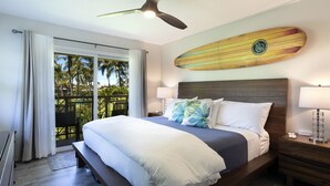 A hotel room with a bed, nightstands, a ceiling fan, and a surfboard decoration on the wall. - 2 - bedroom Waikoloa Townhouse 106, close to beaches and restaurants (Waikoloa Village)