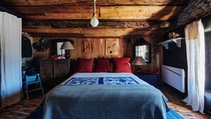 A rustic wooden room with a bed, a dresser, and a window. - Chalet mountain and dog friendly, hot tub (Bourg-Saint-Maurice)