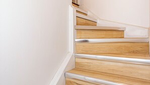 A staircase with wooden steps and white walls. - Newly renovated cozy studio (Woodstock)