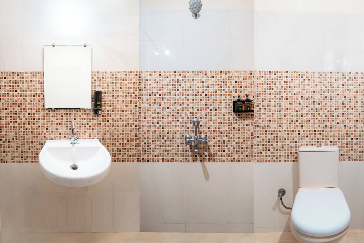 A bathroom with a sink, toilet, and shower.