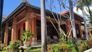A traditional building with a brick facade, large windows, and a tiled roof. - Keyani's Bungalow (Sukasada)