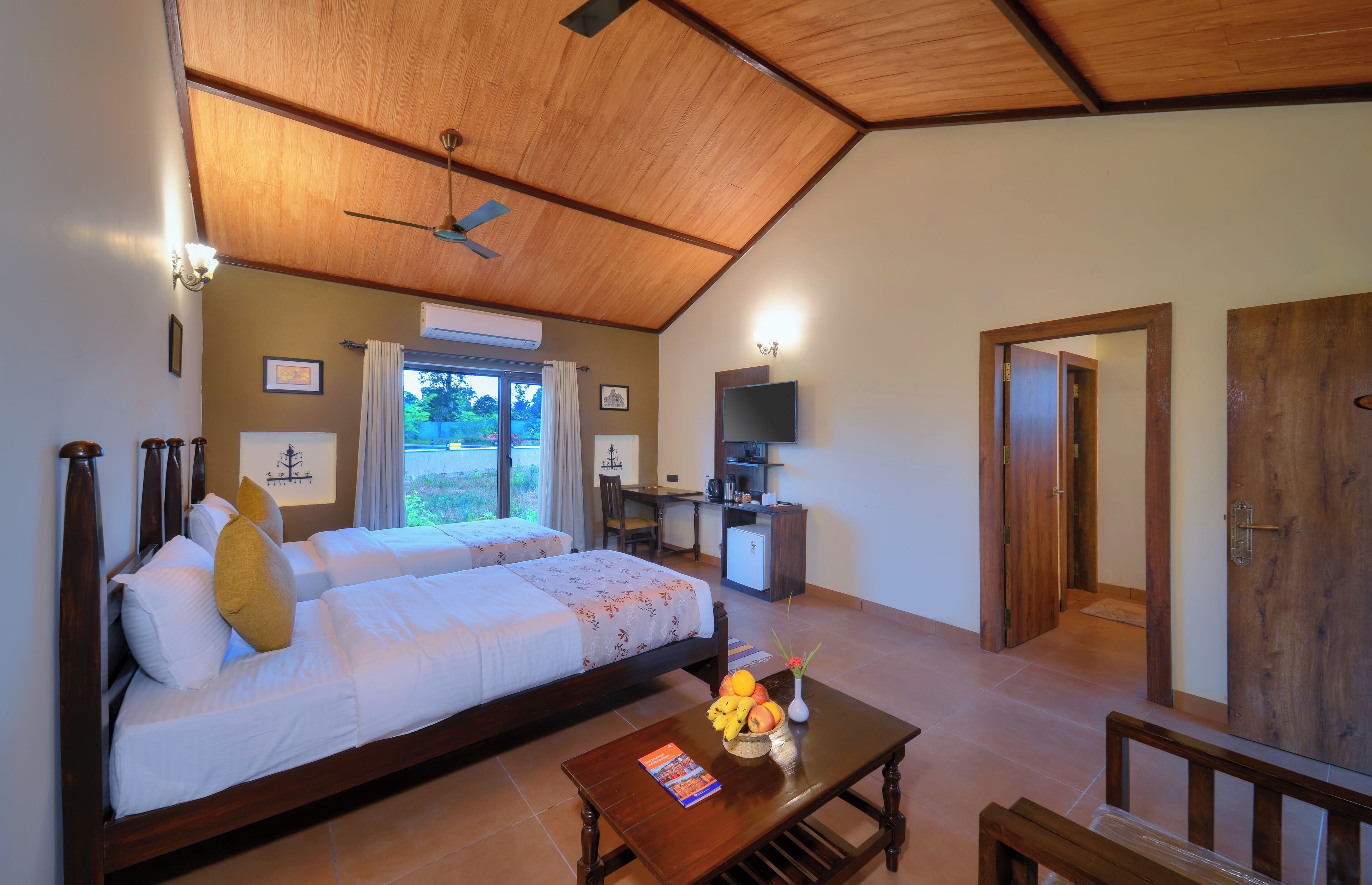 A bedroom with a bed, bedside table, and a TV.