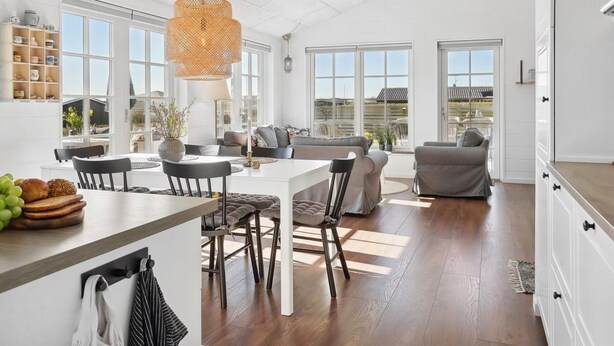 A spacious kitchen with a dining area, large windows, and a high ceiling. - "Ovine" - 300m from the sea by Interhome (Juelsminde)