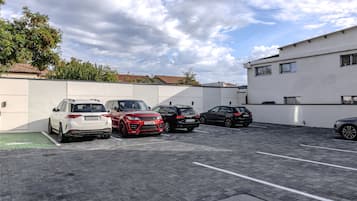 A parking lot with several cars parked in an orderly fashion.