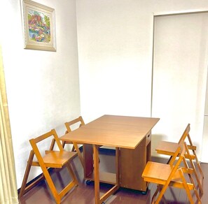 A dining area with a wooden table and four chairs.