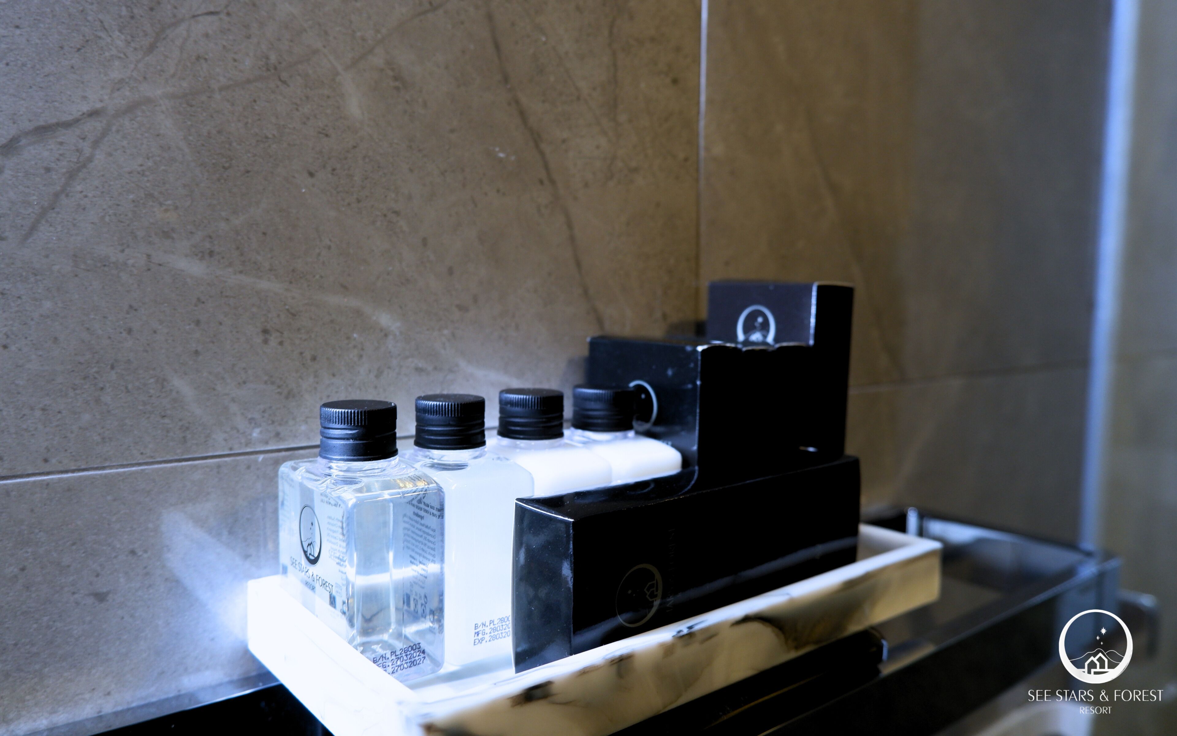 A coffee machine with multiple coffee pods on a marble countertop.