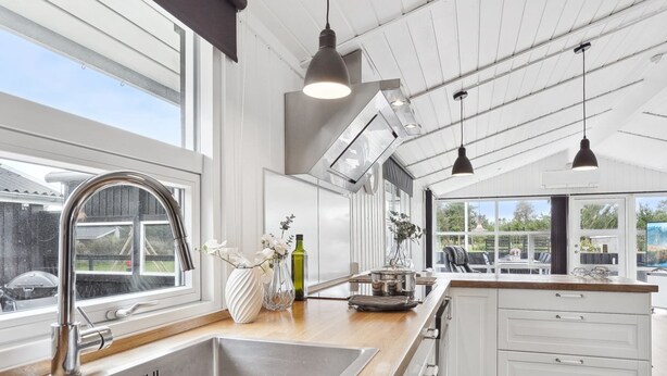 A modern kitchen with a large window, stainless steel sink, and pendant lighting. - "Sylvi" - 750m from the sea by Interhome (Hals)