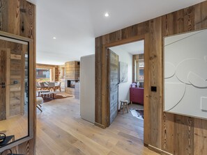 Relax in this open-plan living space with a large artwork, dining area, and comfortable seating.