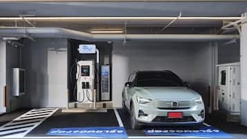 A charging station with a car parked inside a garage.