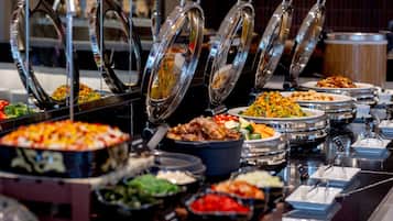 A buffet with various dishes and food containers.