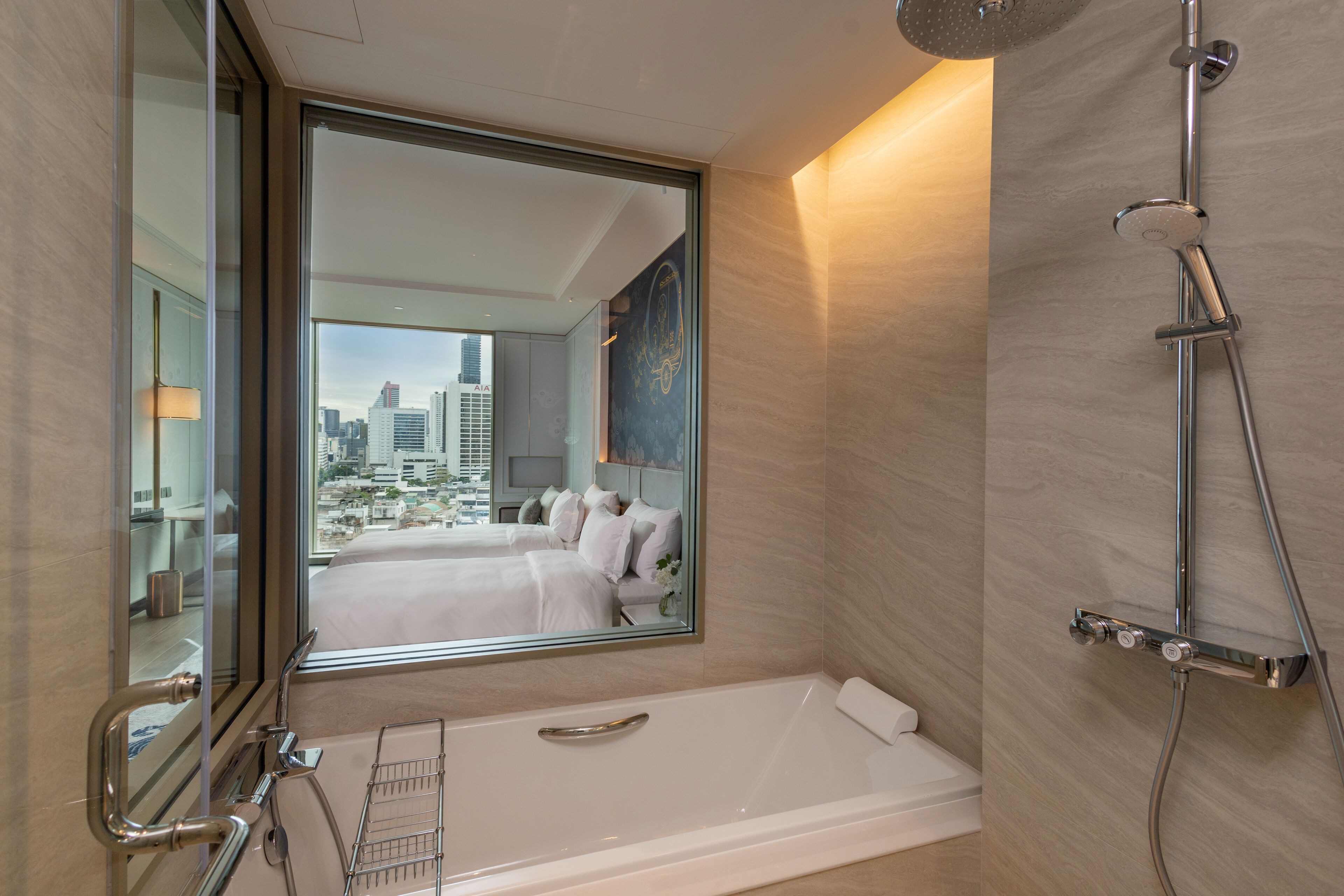 A modern bathroom with a large mirror, a bathtub, and a shower.