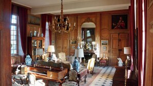 A grand room with a piano, ornate chairs, a chandelier, and a large mirror. - Château de La Rivière (Pontgouin)