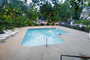 A rectangular pool with a diving board, surrounded by white lounge chairs and a fence. - 3-Bed Athens Getaway right near UGA! Pool, Parking, SmartTV (Athens)