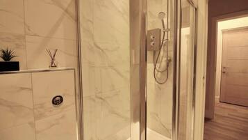 Shower, hair dryer, towels, shampoo