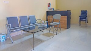 A waiting area with a reception desk, a glass-top table, and several chairs. - Hotel O Losmen Bahalap Syariah MarabahanNearSiring Marabahan (Ulek Barito) (Banjarmasin)