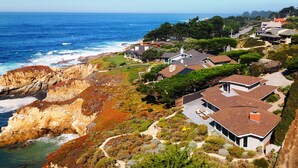 A coastal residential area with houses, a rocky coastline, and the ocean. - 3906 Ocean's One Eleven ~ Unobstructed Ocean View! (Carmel)