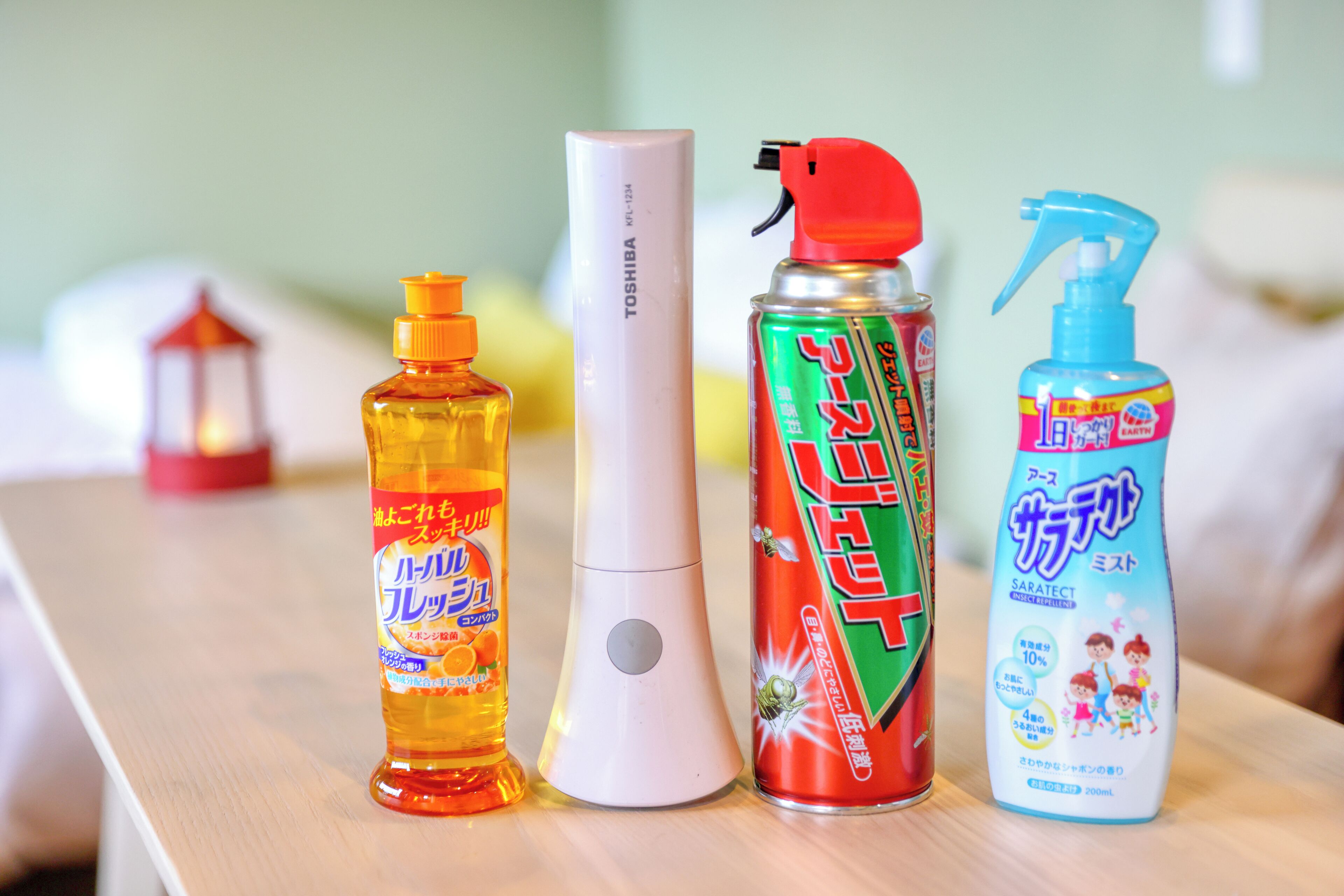 Four cleaning products on a wooden surface.