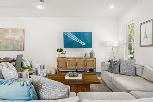 A modern living room with a sofa, coffee table, and a wooden cabinet.