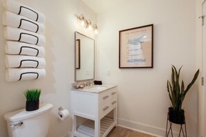 Bathtub, hair dryer, towels, shampoo