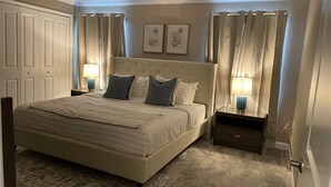 A bedroom with a large bed, two nightstands with lamps, a headboard, and a carpeted floor. - 1094ssp-the Retreat At Championsgate 4 Bedroom Home by RedAwning (Davenport)