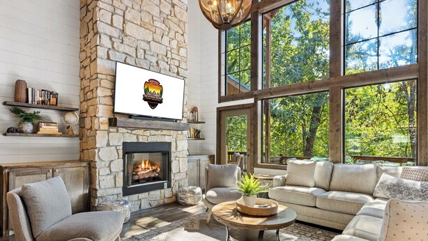 A cozy living room with a stone fireplace, large windows, and comfortable seating. - Southern Honey in Hochatown/Broken Bow, OK (Broken Bow)