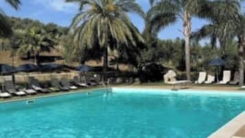 Seasonal outdoor pool, open 9:30 AM to 6:30 PM, pool umbrellas