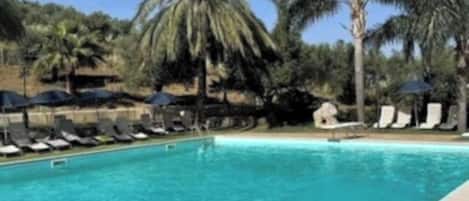 Seasonal outdoor pool, open 9:30 AM to 6:30 PM, pool umbrellas