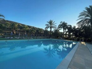 Seasonal outdoor pool, open 9:30 AM to 6:30 PM, pool umbrellas