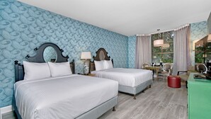 A hotel room with two beds, a desk, a chair, a mirror, and a window with curtains. - Hotel Fiona (San Francisco)