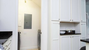 A kitchen with white cabinets, a black countertop, and a built-in oven. - Beautiful Townhome W/pool Close to Disney (Davenport)