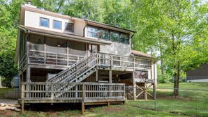 A two-story building with a balcony and a staircase leading to the upper floor. - LakingitEz..3BR/2BA amazing sunsets & hot tub (Inman)