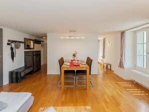 A dining area with a wooden table, chairs, and a bench.