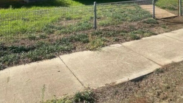 A single-story house with a front porch, a visible antenna, and a fenced yard. - Golden street cottage

 (West Wyalong)