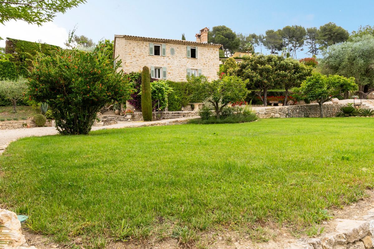 A stone house with a garden in front.