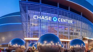 A modern building with a curved facade and the text "CHASE CENTER" prominently displayed.