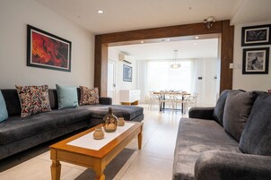 Family Apartment | Living area | 65-inch LCD TV with digital channels, Netflix, heated floors