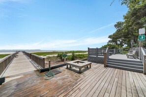 A wooden boardwalk leading to a beach, with a picnic table and benches on the right. - Beachfront Complex - 3 Pools -Tennis - Family Fun! (Hilton Head Island)