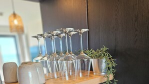 A kitchen counter with wine glasses, a potted plant, and a toaster. - One-room apartment Kaiserhof 311 Norderney with sea view directly on the beach (Norderney)