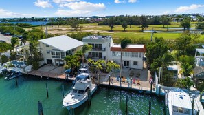 A coastal property with a marina, a pool, and a large building with multiple balconies.