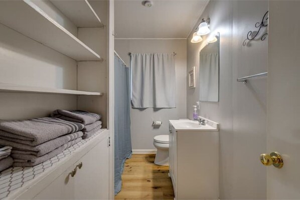 A bathroom with a toilet, sink, and towel rack. - Close to ULM & Meta, Pet Friendly, Fiber Internet, Carport! (Monroe)