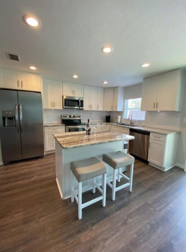 Enjoy cooking in this well-equipped kitchen with a central island and barstools.