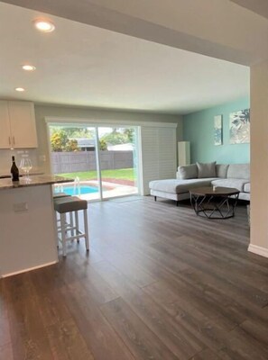 Relax in a spacious living area with a kitchen, dining table, and comfortable seating.
