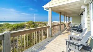A wooden deck with chairs, overlooking a beach and ocean. - Oceanfront Updated 5BR Duplex. Dog friendly! (Emerald Isle)