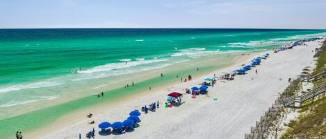 On the beach, white sand, sun-loungers, beach umbrellas