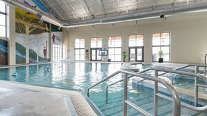 An indoor swimming pool with clear lanes, a lifeguard chair, and a mural on the wall. - Mountain Getaway | Hot Tub & Year-Round Fun (Fraser)