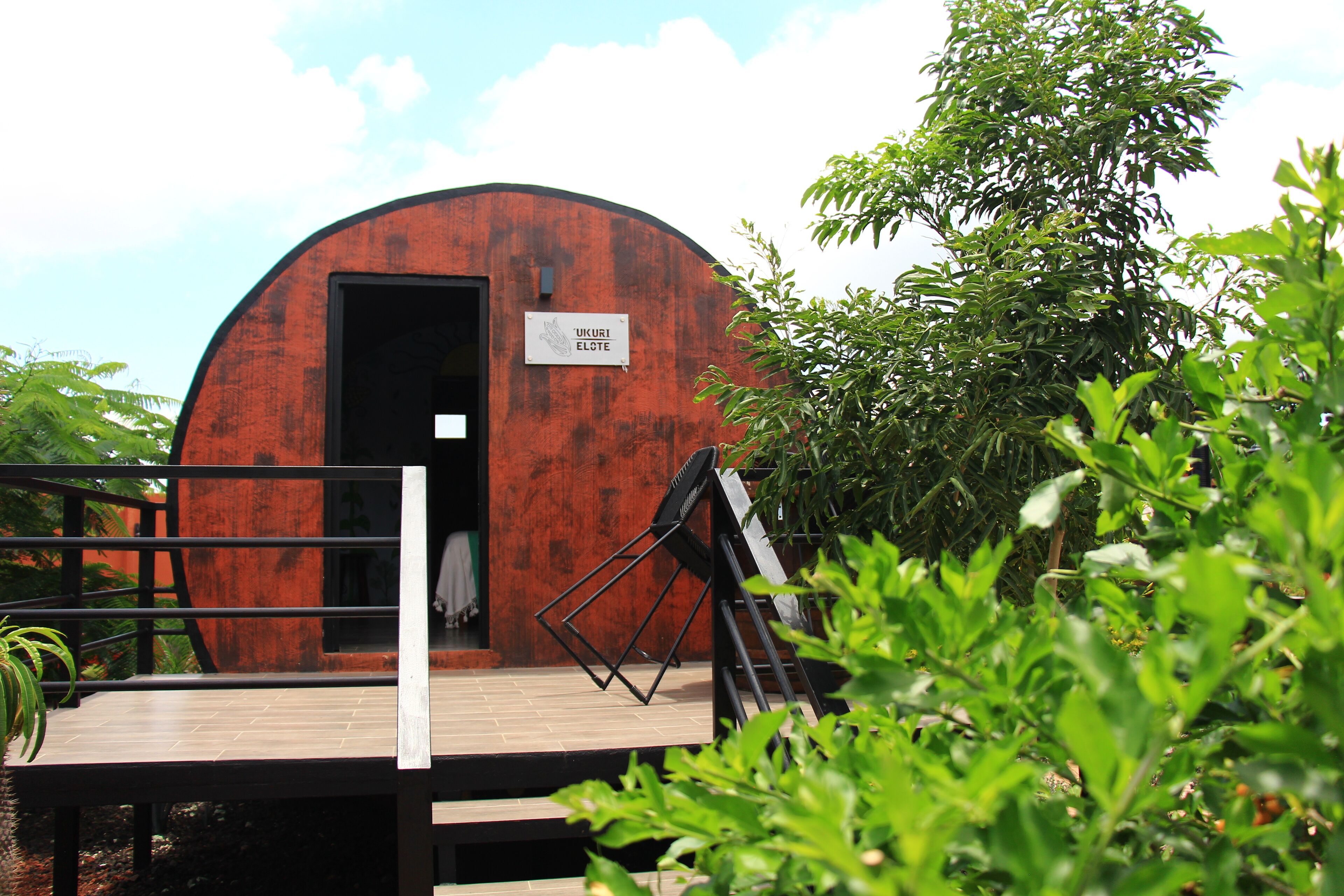 A rustic wooden structure with a sign reading "UKURI ELOTE".