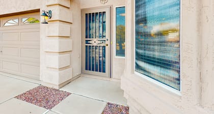 Southwestern home with colorful patio, sparkling pool, grill & dart board