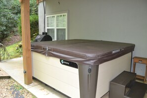 A spa hot tub with a brown cover, a control panel, and a wooden bench. - Creekside, Pet Friendly Mountain Log Cabin in the Smokies,  Fire Pit + Hot Tub  (Franklin)