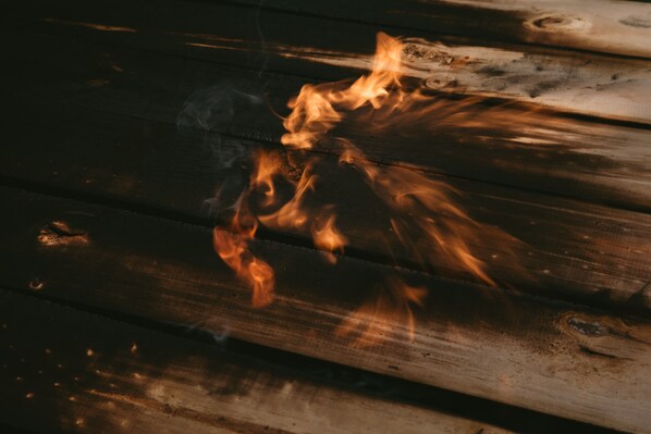 A close-up of a wooden log with flames.
